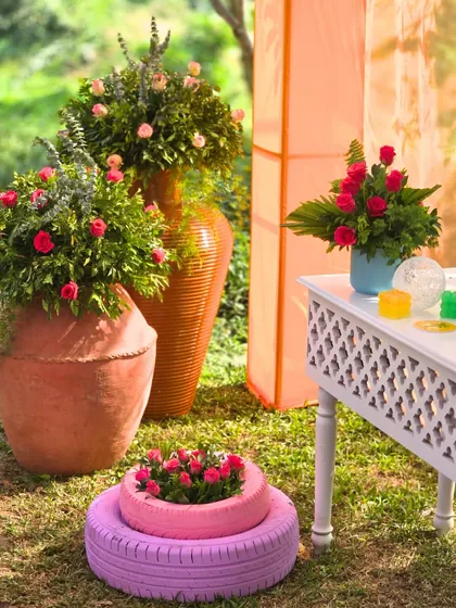 Creative and sustainable decor elements, like planters made from painted tires, filled with beautiful flowers. We love finding unique ways to add color and personality.