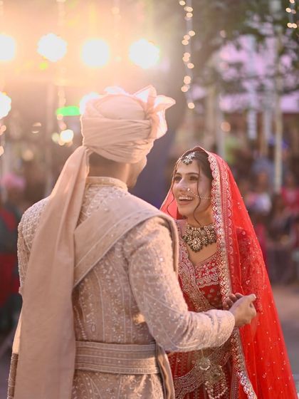 A candid, joyful moment between my bride Jigisha and her groom, her makeup looking fresh and radiant.