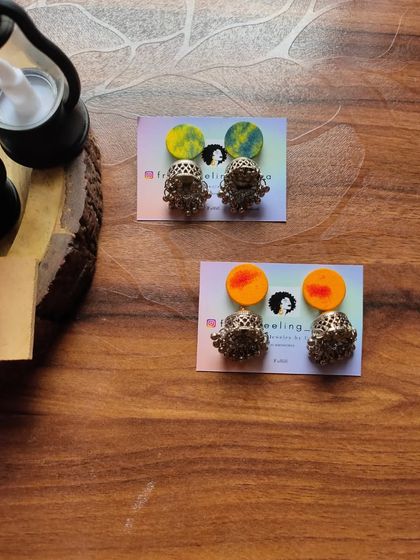 Simple and cute fabric patch studs with jhumki drops. These are available in a variety of hand-painted colors and are a great small accessory for daily traditional wear.