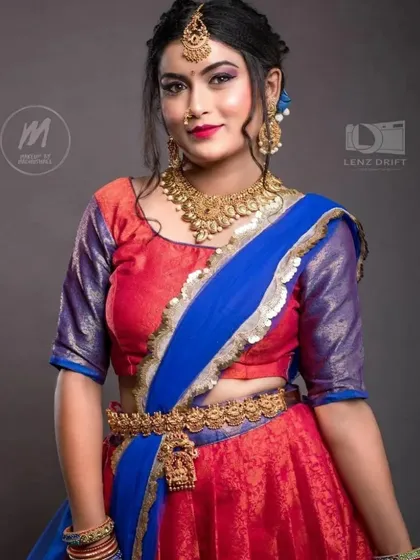 This vibrant half-saree and the matching temple jewellery set are both available for rent. It's a complete look, ready for your special occasion.