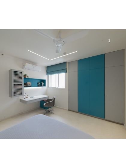 A full view of the kid's room, showcasing the functional layout with an integrated study desk and ample storage. The color blocking with teal and grey provides a modern, youthful vibe that can easily adapt as the child grows.
