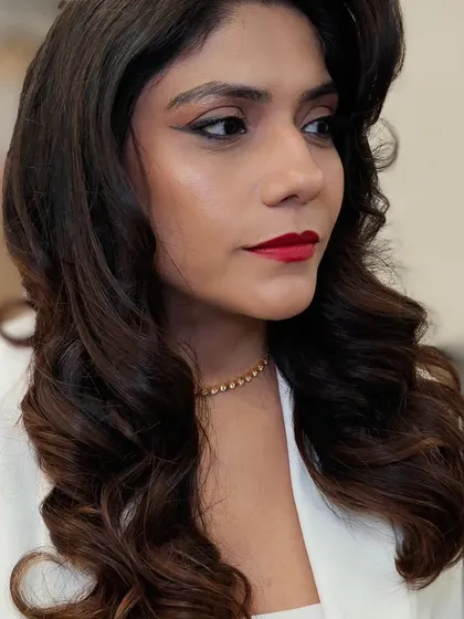 A classic Hollywood glamour look, defined by soft, sculpted waves and a bold red lip. This timeless style is perfect for a wedding reception or any formal event where you want to make a statement.
