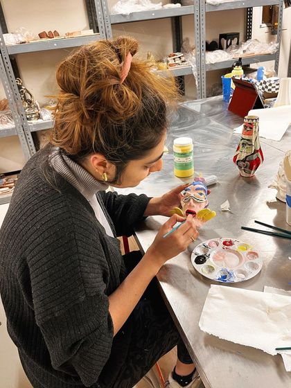 Me in the studio, painting one of the ceramic heads.