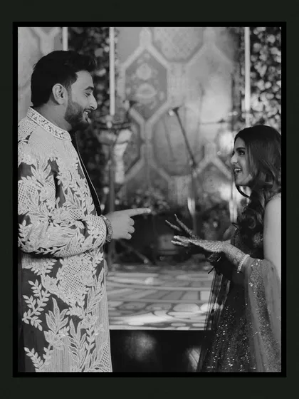 A candid black and white shot of the couple sharing a laugh. This photo perfectly captures their playful interaction and genuine happiness, showcasing the unscripted moments we cherish.