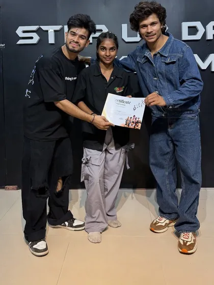 Sarangi proudly holding her certificate. She is now part of the Step Up family.