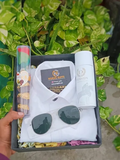 A perfect gift for a formal occasion, this hamper includes a classic white shirt, sunglasses, Denver deodorant, and a tube of delicious chocolates, presented in a neat gift box.