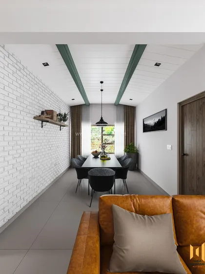 A view from the living room into the long dining area, showing the gabled ceiling with green-painted beams that add character and height.