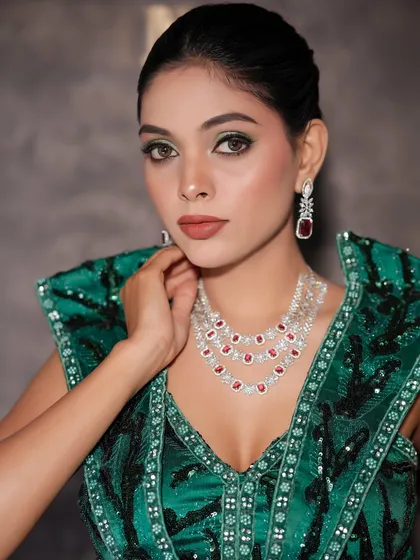 A close-up portrait of the finished glam look, showing the flawless skin and striking eye makeup.