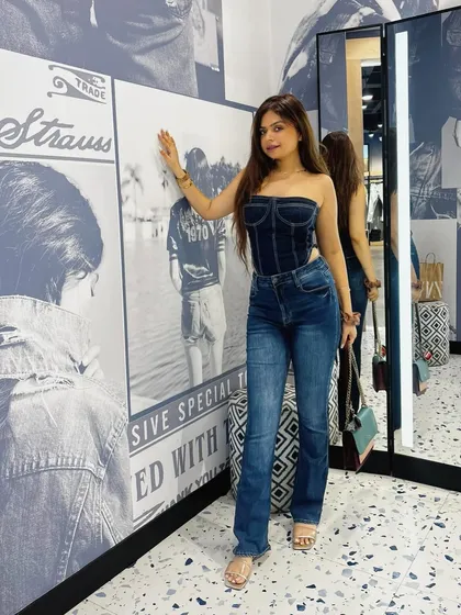 A classic denim-on-denim look. This denim corset bodysuit paired with Levi's flare jeans is a timeless and stylish combination.