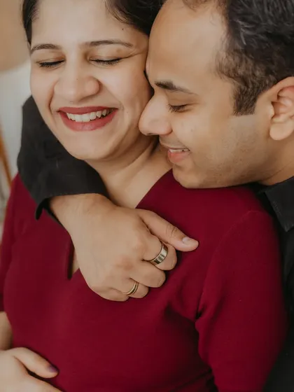 The pure joy of anticipation captured in a candid moment. This close-up from a lifestyle maternity session highlights the genuine laughter and affection between the couple, showing that the most beautiful portraits are often the unposed ones.
