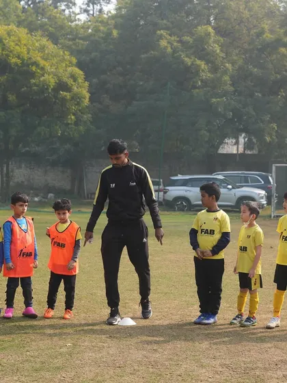 A coach with his team. Our focus extends beyond the game to the long-term growth of each player.
