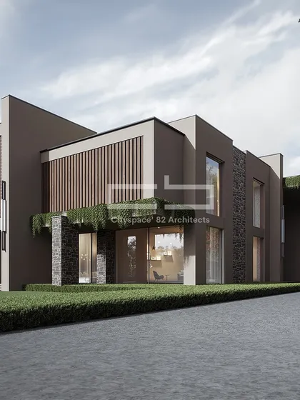A modern home where a rich material palette of stone, wood, and glass is used to create a layered and textured facade. The design balances solid masses with transparent sections, with integrated greenery adding a touch of nature to the structure.