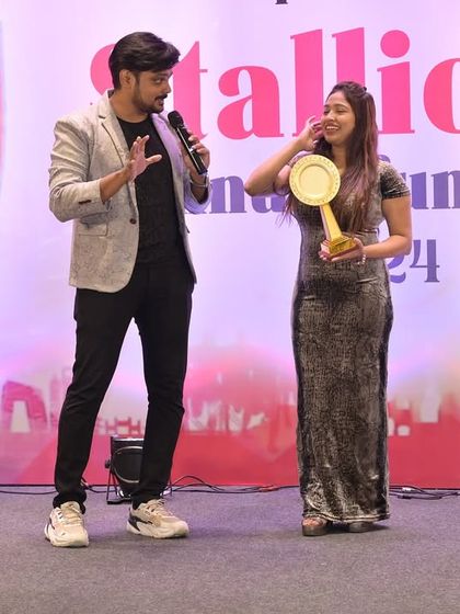 Sharing a light-hearted moment with an award winner on stage. I make sure the awards ceremony feels personal and celebratory, not just a formal list of names.