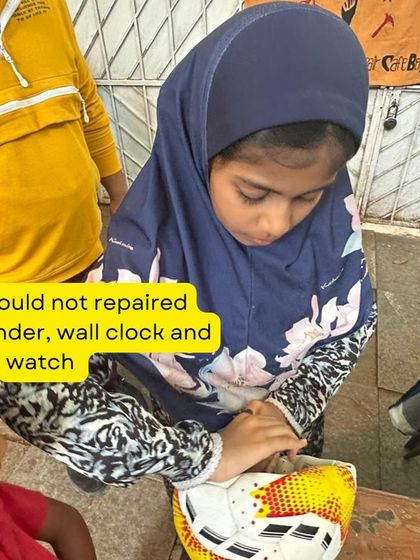 A young girl carefully repairs a football during our Hyderabad workshop. We teach that repair is not limited to electronics or clothes; even sports equipment can often be fixed with a little ingenuity.