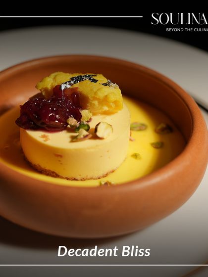 Decadent bliss in a terracotta bowl. This modern Indian dessert features a creamy base, a dollop of jam, and a crumble topping, offering a symphony of textures and flavours.