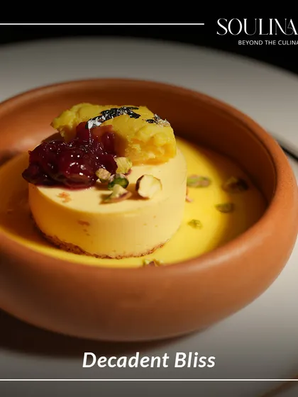 Decadent bliss in a terracotta bowl. This modern Indian dessert features a creamy base, a dollop of jam, and a crumble topping, offering a symphony of textures and flavours.