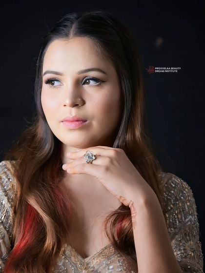 A soft and subtle party look. The hair is styled with gentle waves and features a pop of red for a touch of edge, showing that even simple styles can have a big impact.