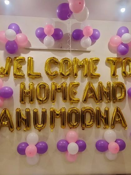 A "Welcome To Home" balloon decoration on the wall to celebrate the arrival of a new baby.