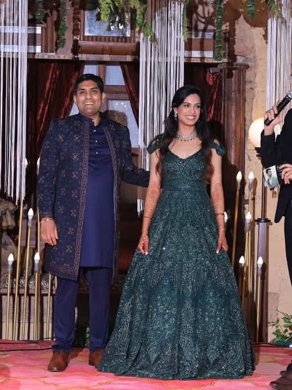 On stage with the happy couple, steering the rhythm and anchoring the vibes to weave magic at their Sangeet night.