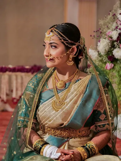 This bride's look is a beautiful example of traditional Coorgi style. The makeup is elegant and understated, perfectly complementing the unique way the saree is draped.