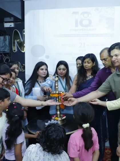 The traditional lamp lighting ceremony at our 18th-anniversary celebration, with our team and clients participating together.