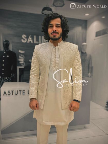 A client in a simple, elegant off-white kurta set with a matching textured open jacket. This is a great example of understated style.