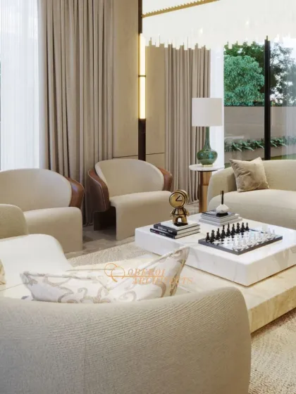 A close-up view of the living area, highlighting the mix of textures from the bouclé armchairs to the smooth marble coffee table. The chess set adds a personal and intellectual touch.