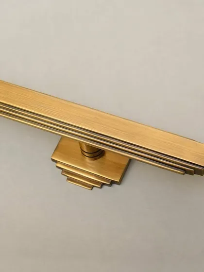 A detail shot of the Natali door pull's stepped base, showcasing the Art Deco influence and the precision of our machining.
