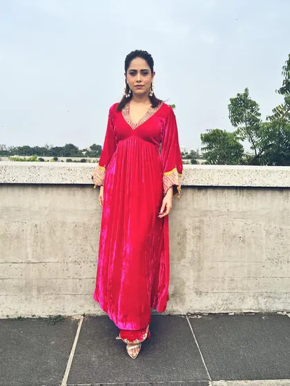 A pop of pink for Nushrratt Bharuccha in Ahmedabad. This velvet maxi dress with embellished cuffs is a comfortable yet glamorous choice for travel and promotional events.