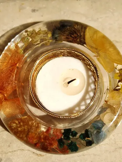 This top-down view of a floral resin diya shows the variety of flowers I can preserve. The mix of colors and textures creates a small, contained garden around the candle.