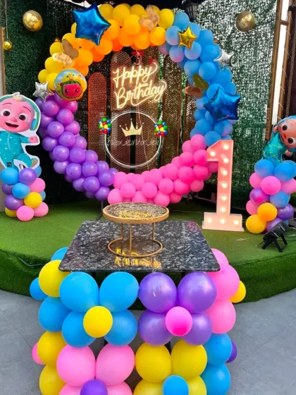I can create decorations for any kids' theme. Here is a Cocomelon themed first birthday party, with a colorful balloon ring, character cutouts, and a light-up number '1' to make the milestone special.