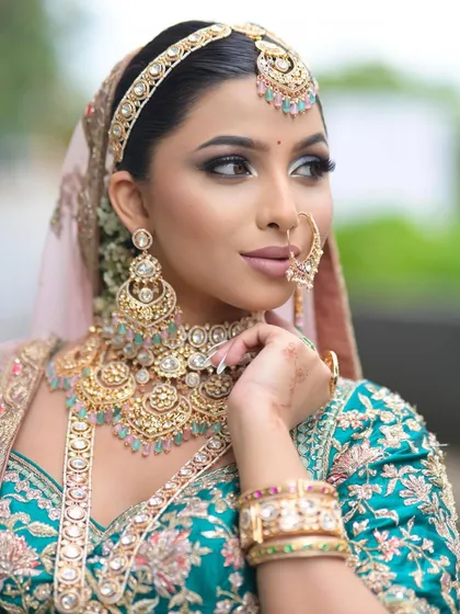 A side profile that captures the elegance of the look. The contouring is soft yet effective, and the eye makeup is perfectly blended.