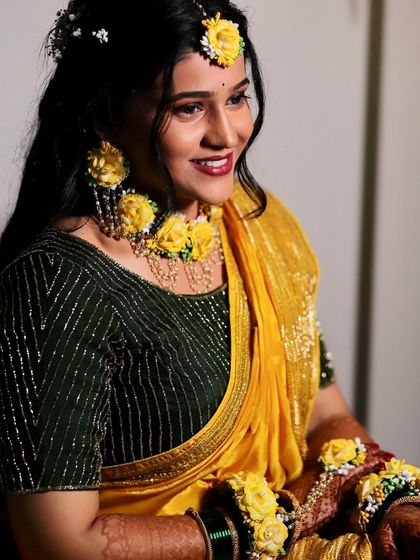 Another beautiful shot from the Haldi ceremony. The bride's smile is infectious, and her makeup is designed to last through all the fun and rituals.