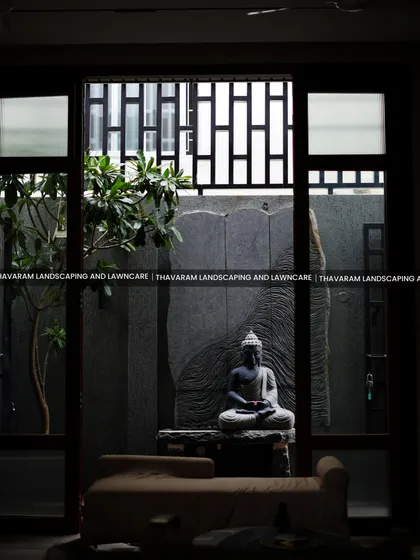 I believe a garden should bring peace that extends into your home. This view from inside shows how we can create a tranquil courtyard, featuring a serene Buddha statue and natural stone, turning your window into a living piece of art.