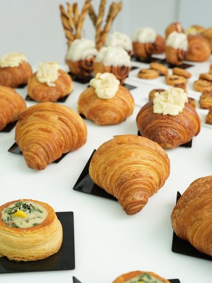 A stunning display of croissants and other viennoiserie created by our students. This image shows the variety and professional quality of the pastries made in our classes.