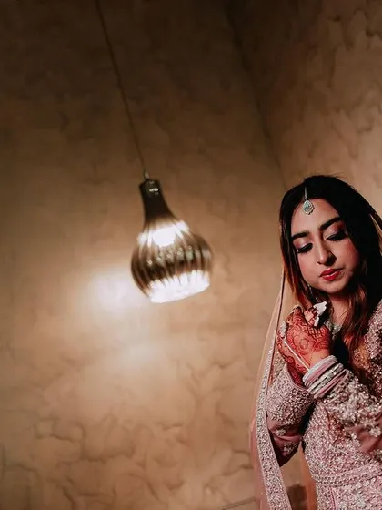 A portrait of a Muslim bride in a beautifully embellished gown, captured in a moment of quiet elegance.