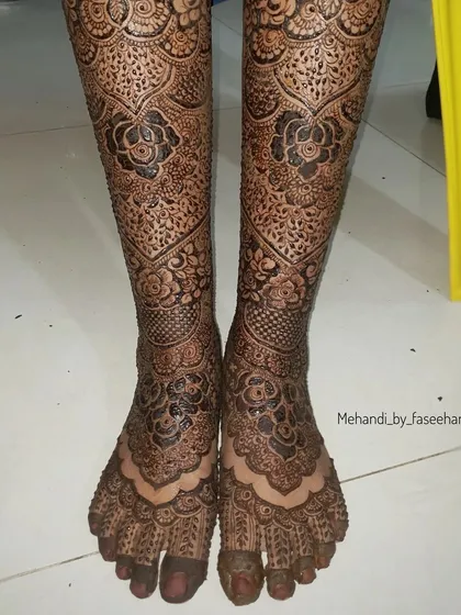 Full coverage bridal legs, featuring dense floral and traditional patterns from toes to shin.