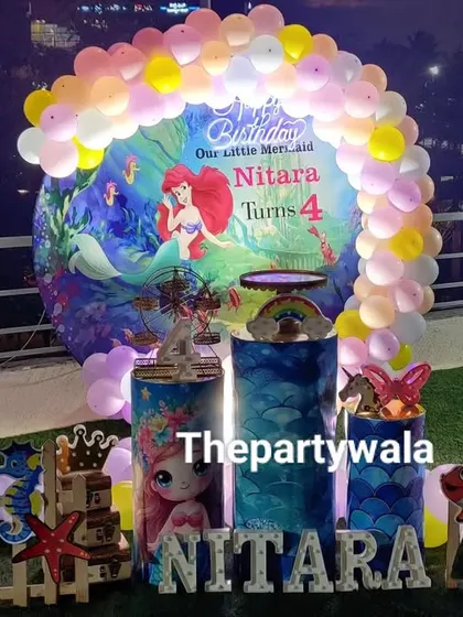 Another view of the rooftop Mermaid party, showing the complete setup with the pastel balloon arch and all the under-the-sea characters.