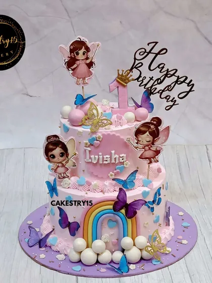A magical two-tier pineapple cake for a fairyland-themed first birthday. This creation is adorned with charming fairy toppers, colorful butterflies, and a fondant rainbow for a whimsical touch.