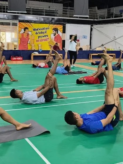 A strong body and a focused mind are inseparable. Here, our athletes engage in a guided stretching session, part of our integrated yoga program designed to improve flexibility, prevent injuries, and enhance on-court performance.