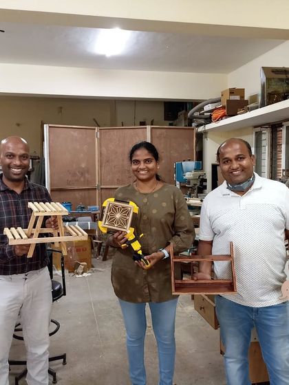 Varun, Kanthi, and Rajashekhar with their diverse set of projects. We have a miniature picnic table, a Kumiko box, and the first day's projects from a basic carpentry workshop.