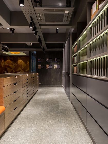 A long view of the showroom, showing the organized and well-lit shelving systems that house hundreds of samples.