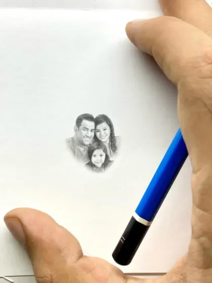 The full view of the miniature Dhoni family portrait, showing just how small it is compared to my hand and a standard pencil.