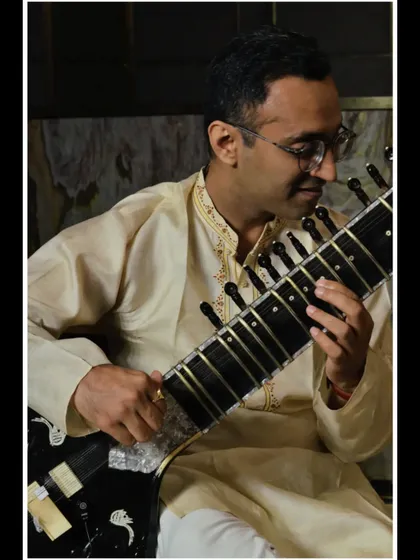 A side-view portrait, highlighting the details of the sitar.