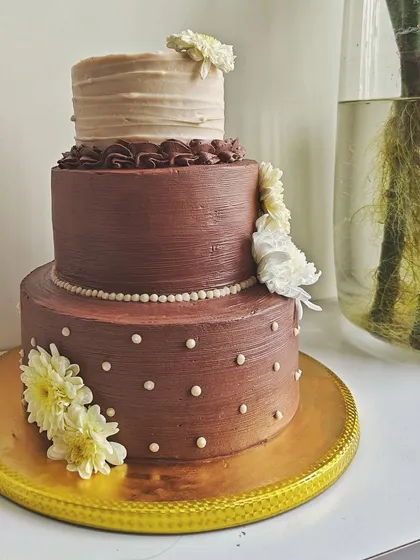 A wedding cake should be a memorable centerpiece. I designed this rustic three-tiered chocolate cake for a beautiful wedding, using different textures on each layer and decorating it with fresh, delicate flowers.