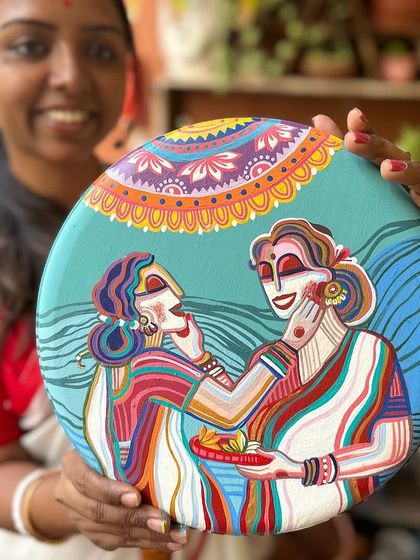 This plate from the set captures the playful tradition of Sindoor Khela, where women apply vermilion to each other on the last day of Durga Puja.