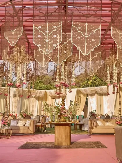 A wide view of the stunning lounge area, with its canopy of golden mesh panels and floral chandeliers creating a luxurious and dreamy atmosphere.