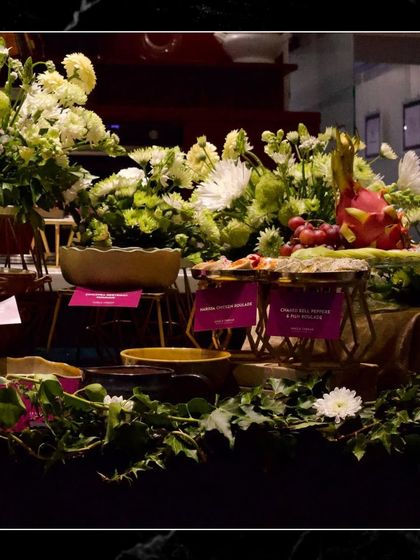 Another angle of the lush grazing table, showing how I use fresh greenery and flowers to enhance the visual appeal of the food spread.