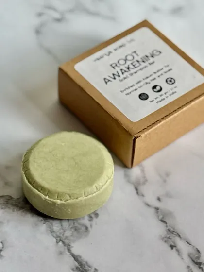 Our 'Root Awakening' solid shampoo bar is enhanced with Kokum Butter, Green Clay, and Coconut Oil to detoxify, nourish, and revitalize your scalp.