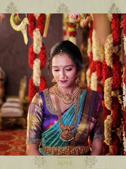 A bride in a multi-toned Kanchipuram saree. Her custom blouse features subtle embroidery that complements the rich colors of the silk.